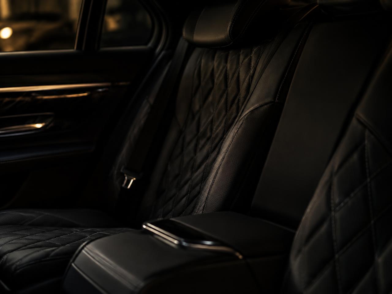 Quilted black leather rear seat of a luxury vehicle